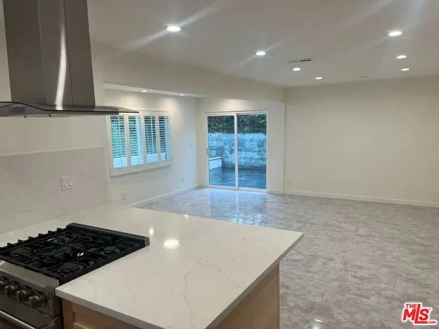 a view of a kitchen with a sink dishwasher and wooden floor