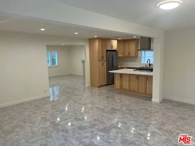 a view of a kitchen with a sink a refrigerator and window