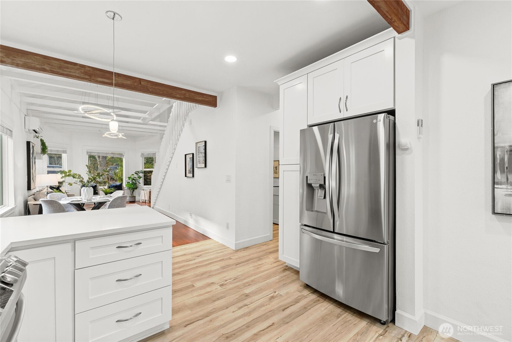 424 27th Avenue East Seattle, WA 98112 - Photo 11 of 36 a kitchen with stainless steel appliances a refrigerator and a cabinets