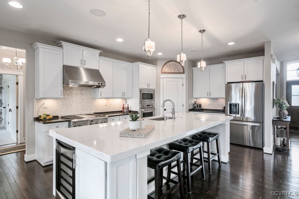 16413 Lambourne Road Midlothian, VA 23112 - Photo 8 of 33 a kitchen with stainless steel appliances a stove a sink a refrigerator a center island and a chairs