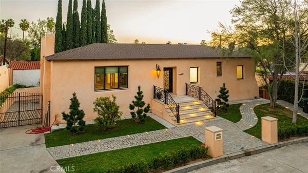 a front view of a house with garden