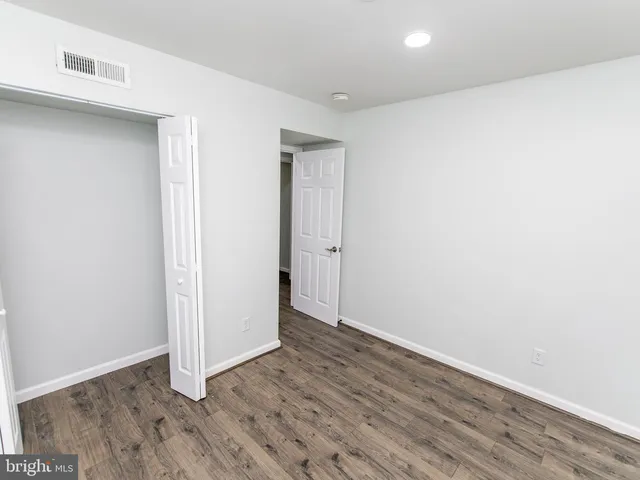 an empty room with wooden floor