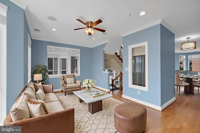 a living room with furniture and a wooden floor