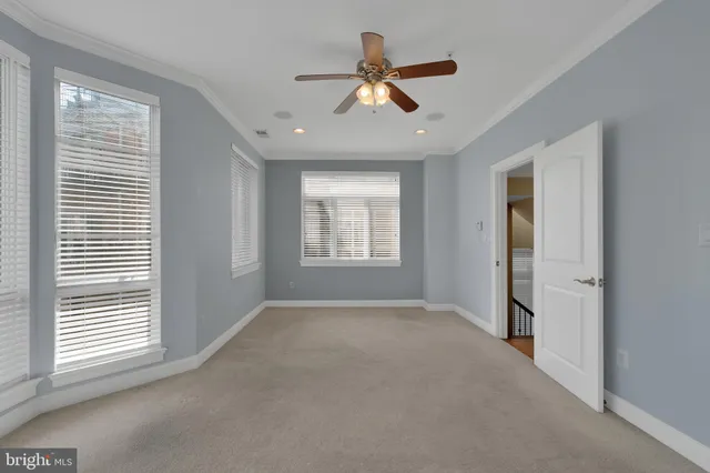 a view of a livingroom with a ceiling fan and window