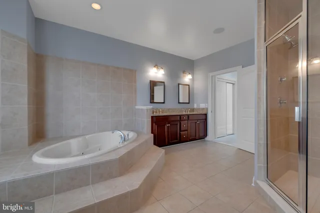a spacious bathroom with a tub sink and shower