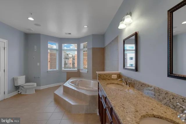 a spacious bedroom with a bed and a window