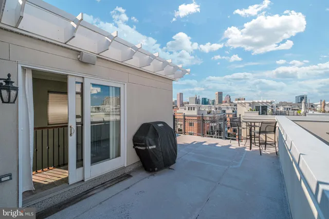 a balcony with a table and chairs