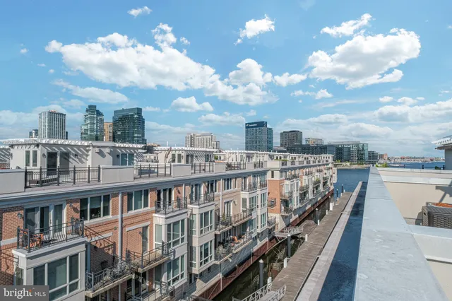 a view of a patio with furniture and table under an umbrella