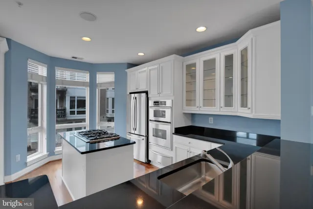 a kitchen with refrigerator and stove