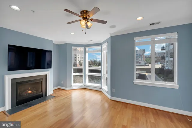 a view of an empty room with a fireplace and a window