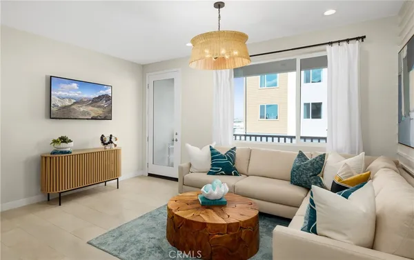 a living room with furniture and a chandelier