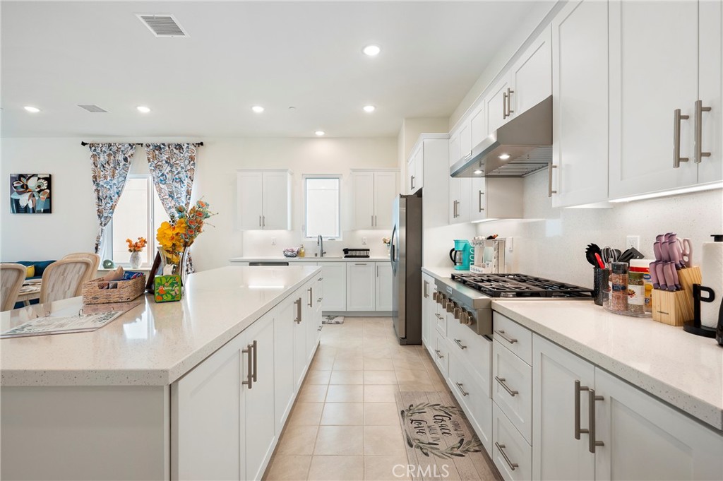 2053 Peebler Way Tustin, CA 92782 - Photo 12 of 37 a kitchen with a sink stove and cabinets
