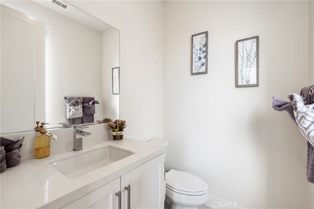 2053 Peebler Way Tustin, CA 92782 - Photo 17 of 37 a bathroom with a sink toilet and vanity