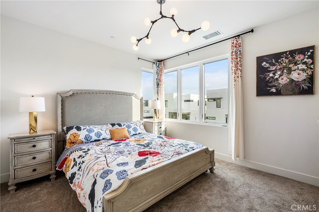 2053 Peebler Way Tustin, CA 92782 - Photo 22 of 37 a bedroom with a bed a dresser and next to a window