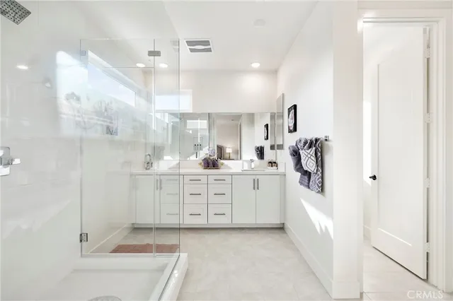 a bathroom with a tub sink shower and mirror