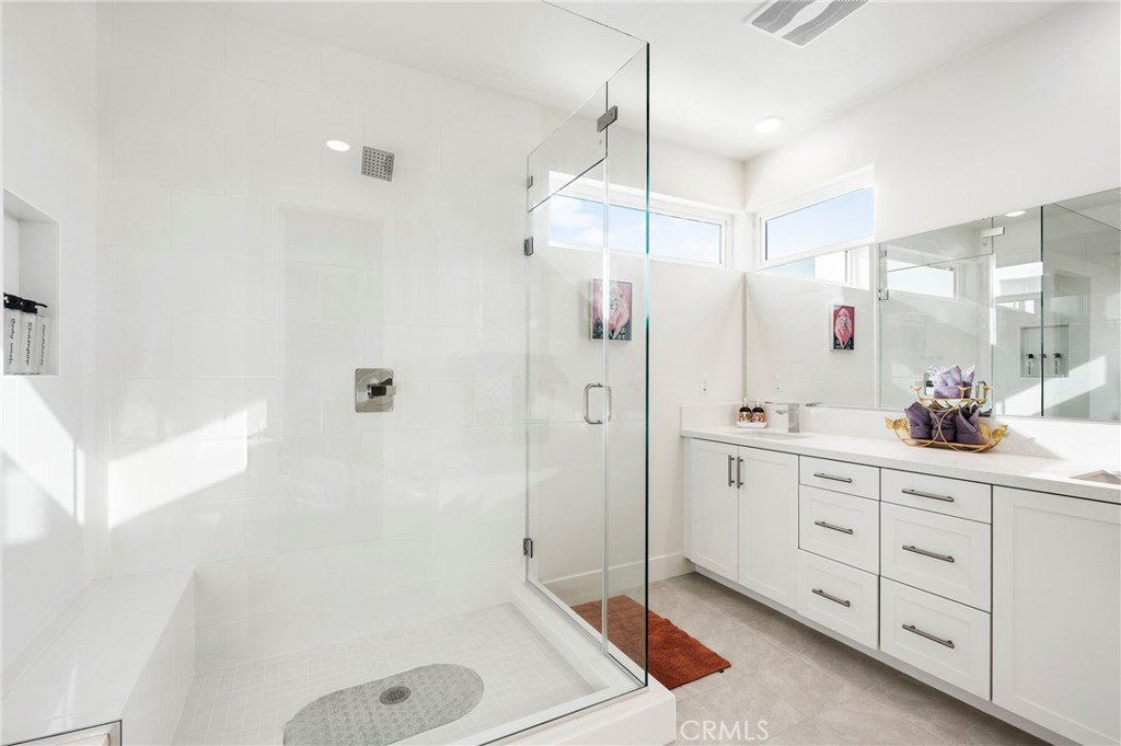 2053 Peebler Way Tustin, CA 92782 - Photo 25 of 37 a bathroom with a tub sink shower and mirror