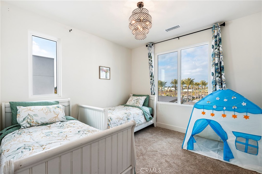 2053 Peebler Way Tustin, CA 92782 - Photo 28 of 37 a bedroom with a bed and a large window