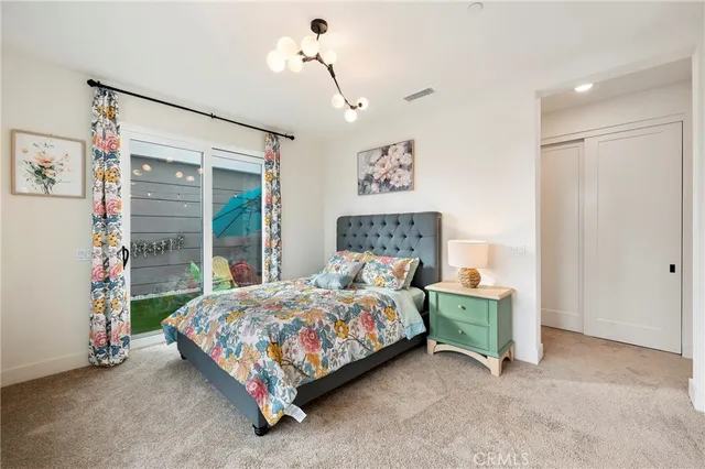 a bedroom with bed and wooden floor