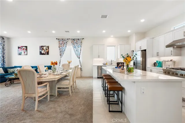 a kitchen with a sink a counter top stainless steel appliances and cabinets