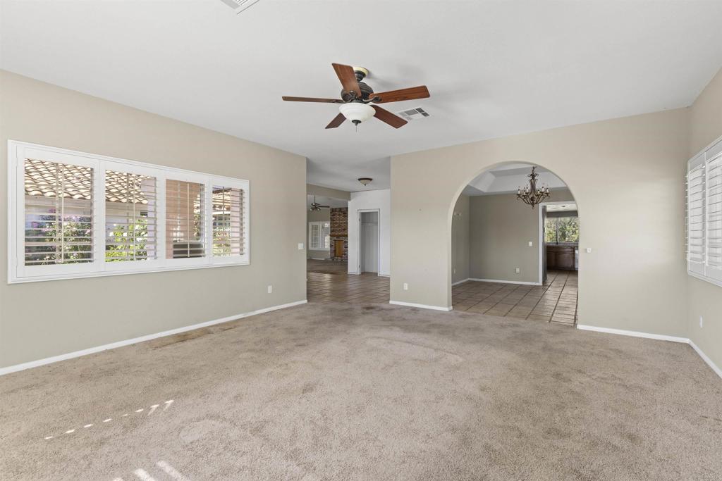 1007 Capra Way Fallbrook, CA 92028 - Photo 17 of 44 an empty room with windows and ceiling fan