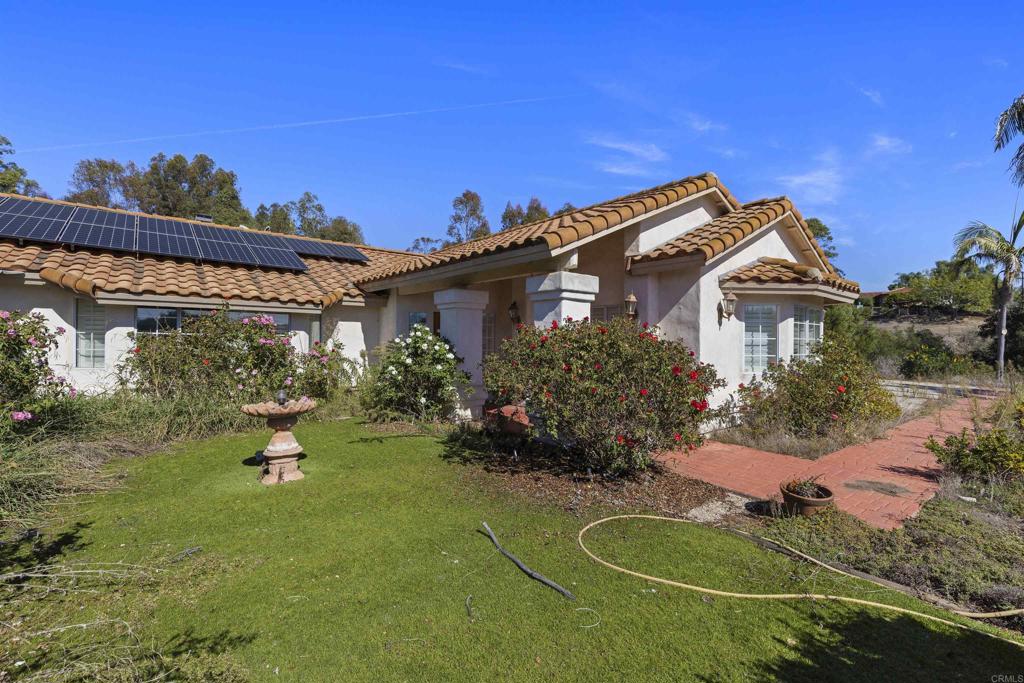 1007 Capra Way Fallbrook, CA 92028 - Photo 2 of 44 a backyard of a house with table and chairs and potted plants