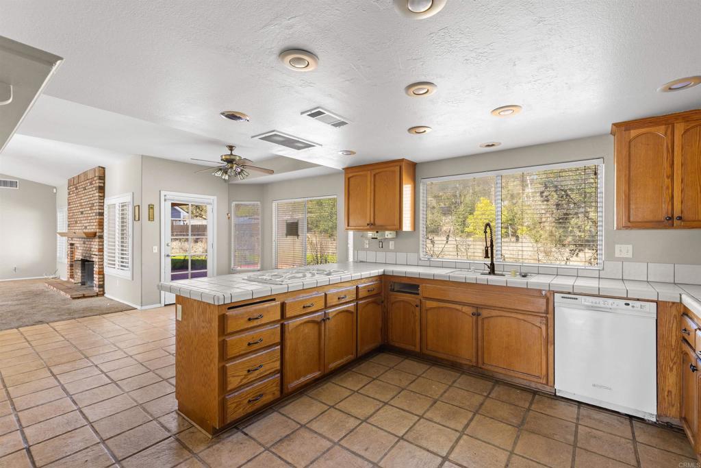 1007 Capra Way Fallbrook, CA 92028 - Photo 24 of 44 a large kitchen with a sink and cabinets