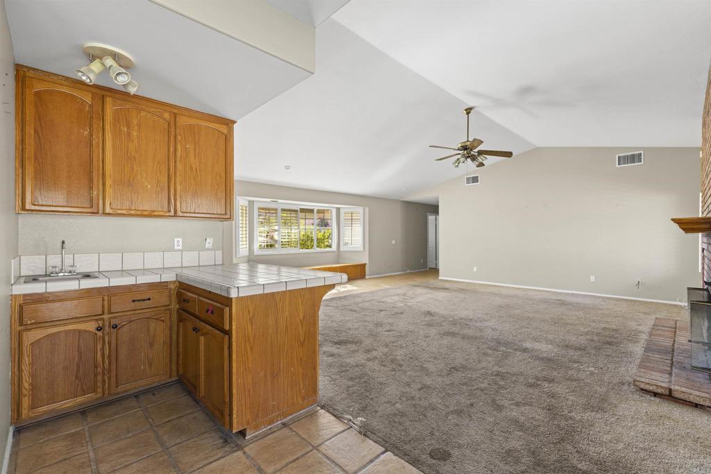 1007 Capra Way Fallbrook, CA 92028 - Photo 26 of 44 a kitchen with a sink and cabinets