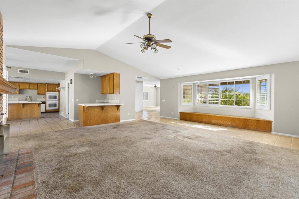 1007 Capra Way Fallbrook, CA 92028 - Photo 27 of 44 a view of an empty room with a window and a kitchen