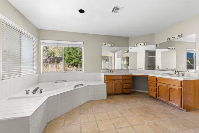 a spacious bathroom with a tub and a shower