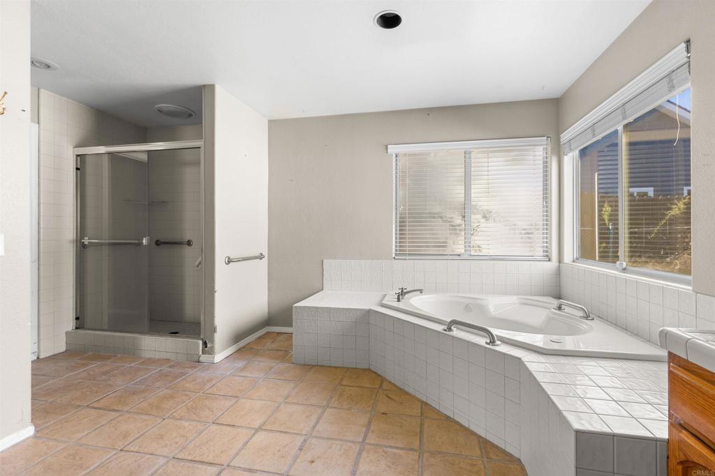 1007 Capra Way Fallbrook, CA 92028 - Photo 34 of 44 a spacious bathroom with a tub and a shower