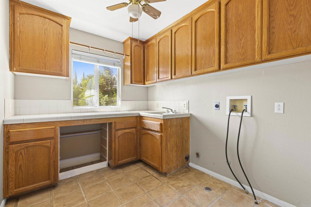 1007 Capra Way Fallbrook, CA 92028 - Photo 38 of 44 a kitchen with stainless steel appliances granite countertop a sink window and cabinets