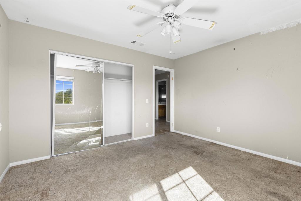 1007 Capra Way Fallbrook, CA 92028 - Photo 41 of 44 an empty room with closet and a chandelier fan