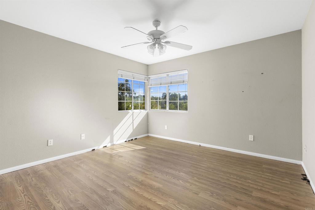1007 Capra Way Fallbrook, CA 92028 - Photo 43 of 44 wooden floor in an empty room with a window