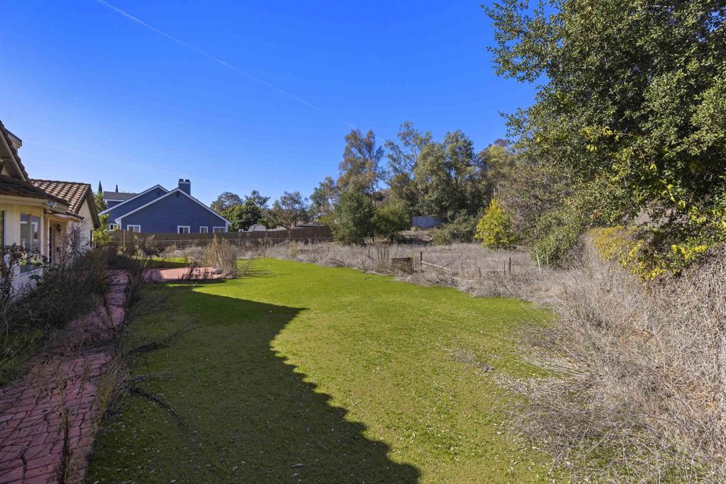 1007 Capra Way Fallbrook, CA 92028 - Photo 9 of 44 a view of a house with a big yard