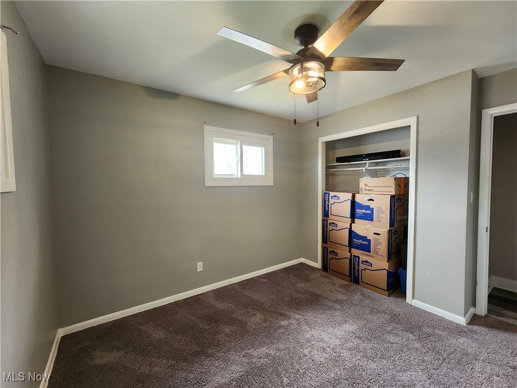 667 Sterling Road Wickliffe, OH 44092 - Photo 16 of 41 Unfurnished bedroom with a closet, a ceiling fan, baseboards, and dark carpet