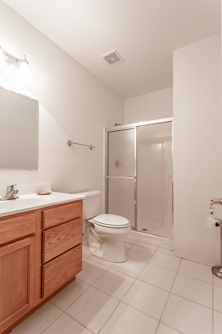 2019 East Kentucky Road Beecher, IL 60401 - Photo 45 of 47 a bathroom with a toilet sink vanity and mirror