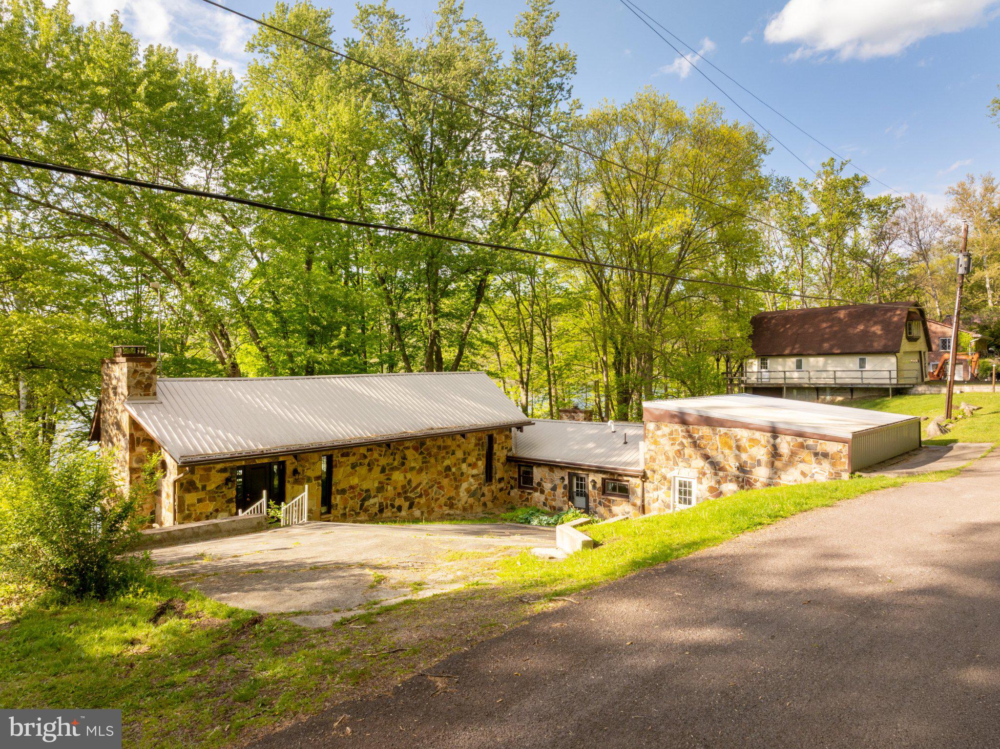 750 Lake Side Road Addison, PA 15411 - Photo 4 of 51 Charming stone home by lush greenery.