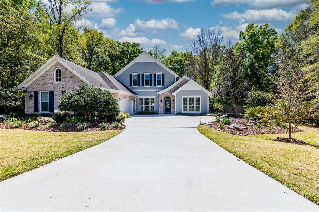 10257 Southwest 37 Place Gainesville, FL 32608 - Photo 1 of 44 a front view of a house with yard and green space