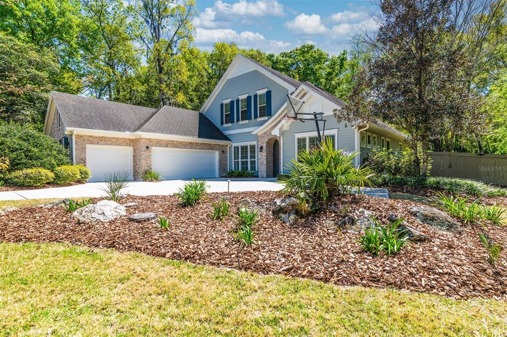 10257 Southwest 37 Place Gainesville, FL 32608 - Photo 2 of 44 a front view of a house with garden