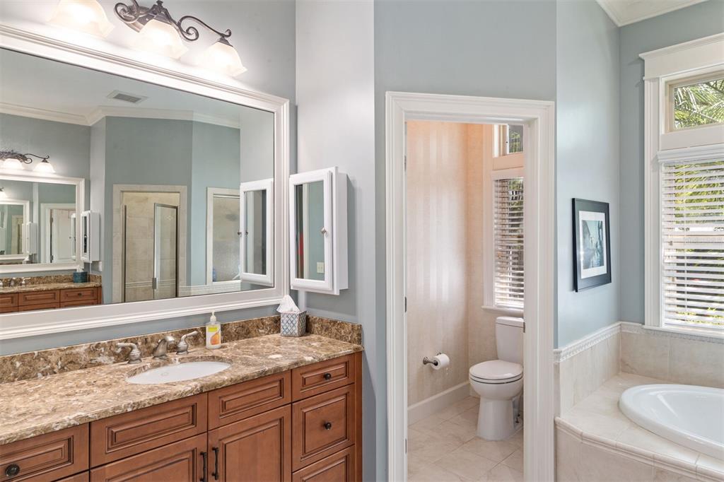 10257 Southwest 37 Place Gainesville, FL 32608 - Photo 22 of 44 a bathroom with a granite countertop sink toilet and shower