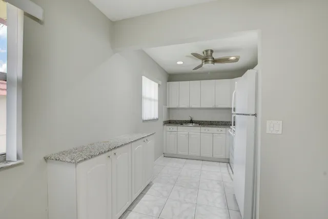 a kitchen with refrigerator a stove a microwave and cabinets