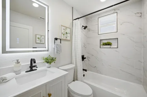 a bathroom with a sink toilet and shower
