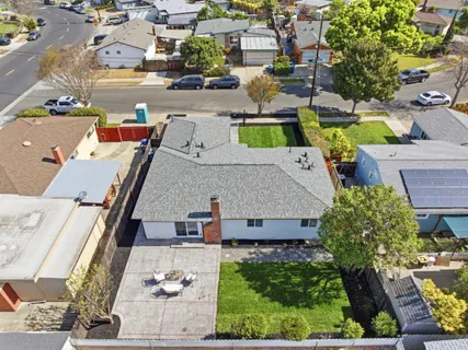 an aerial view of residential houses with outdoor space