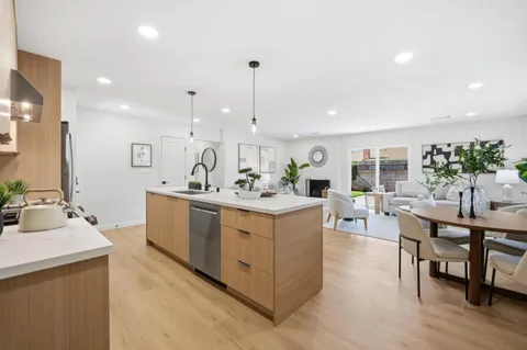a living room with furniture a dining table and chairs