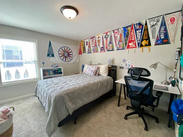 a bedroom with a bed and a desk