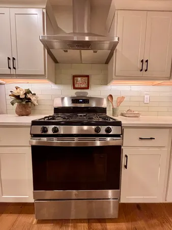 a stove top oven sitting inside of a kitchen