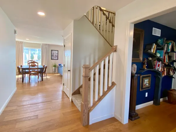 a view of entryway and hall with wooden floor