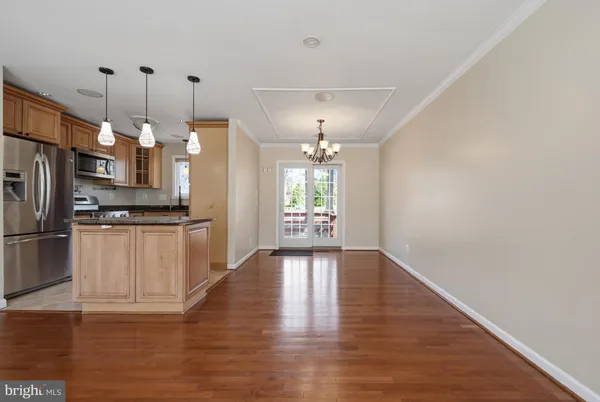 a kitchen with stainless steel appliances granite countertop a refrigerator a oven and a sink