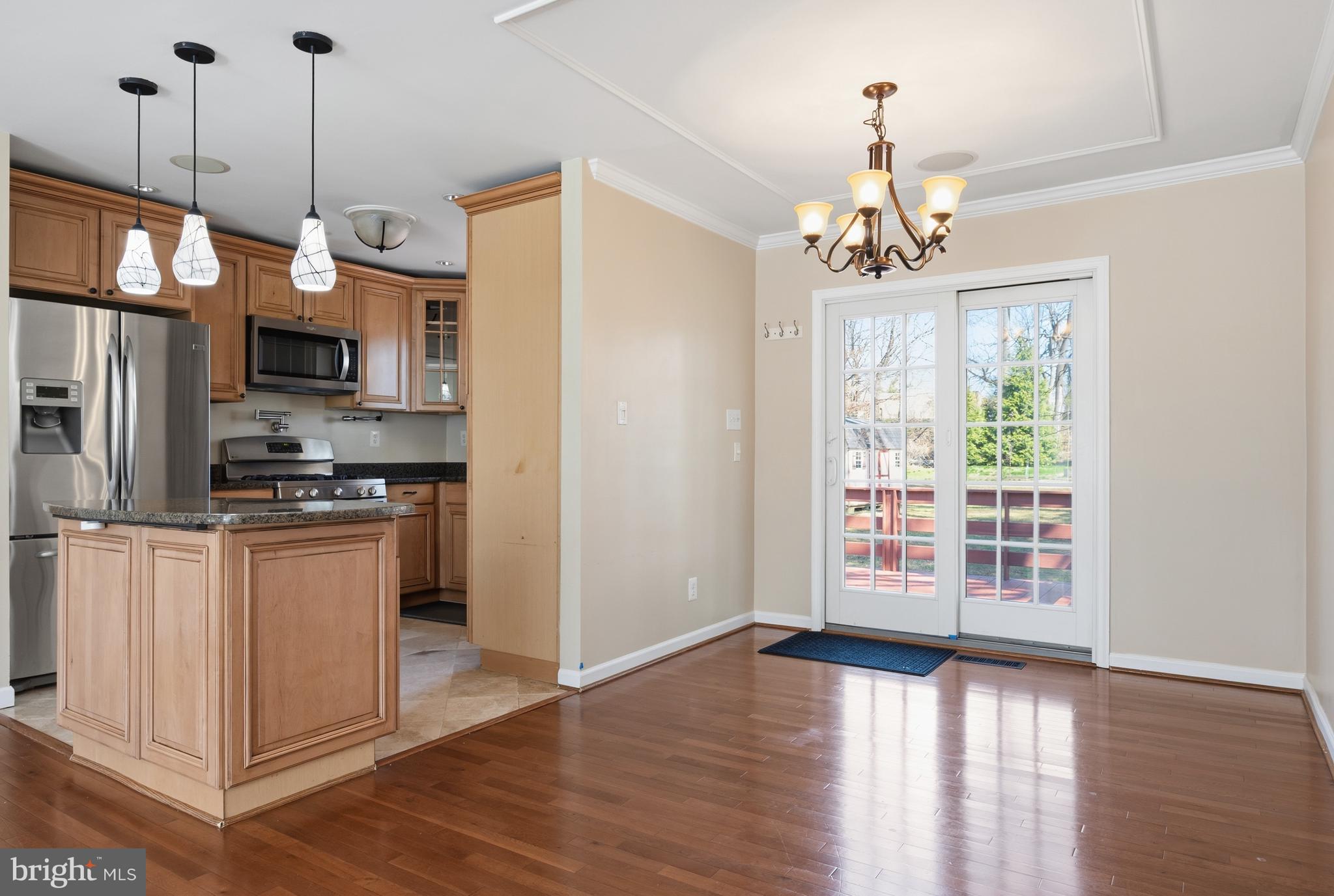 124 Woodland Road Gaithersburg, MD 20877 - Photo 12 of 79 a kitchen with stainless steel appliances granite countertop a refrigerator a sink a stove and a wooden floors