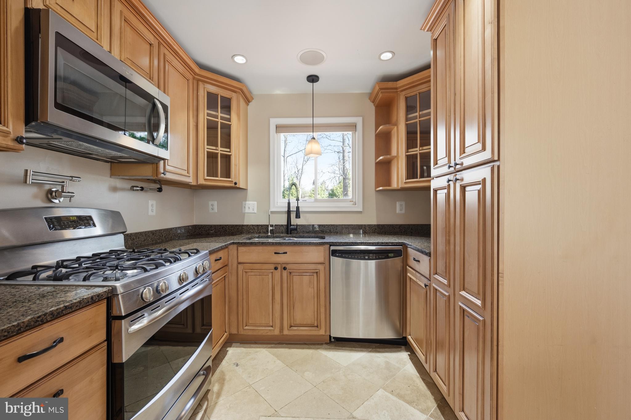 124 Woodland Road Gaithersburg, MD 20877 - Photo 15 of 79 a kitchen with stainless steel appliances granite countertop a stove top oven a sink dishwasher a microwave oven and a refrigerator